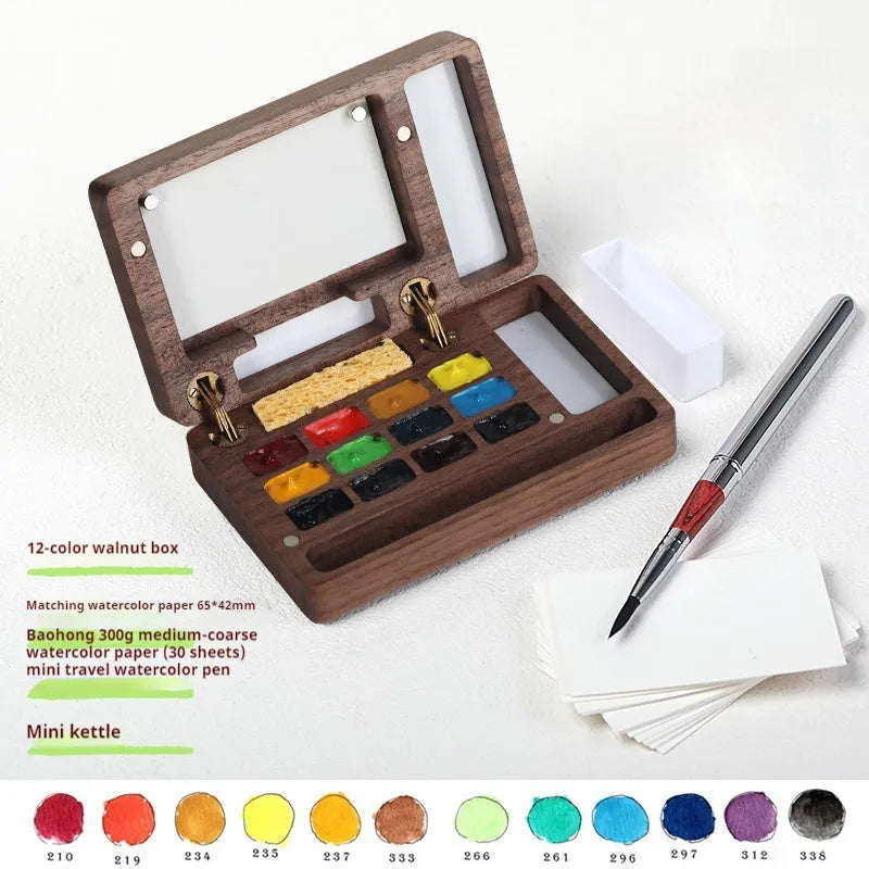 Mini wooden watercolour paint box open to show pigment pans inside.