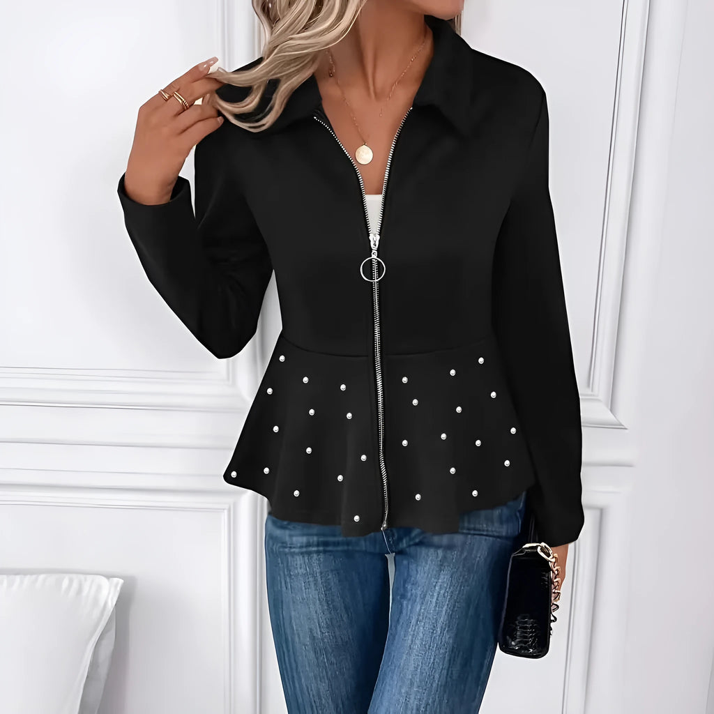 Women's loose black coat with heavy-duty zipper and ruffled hem, shown on a hanger
