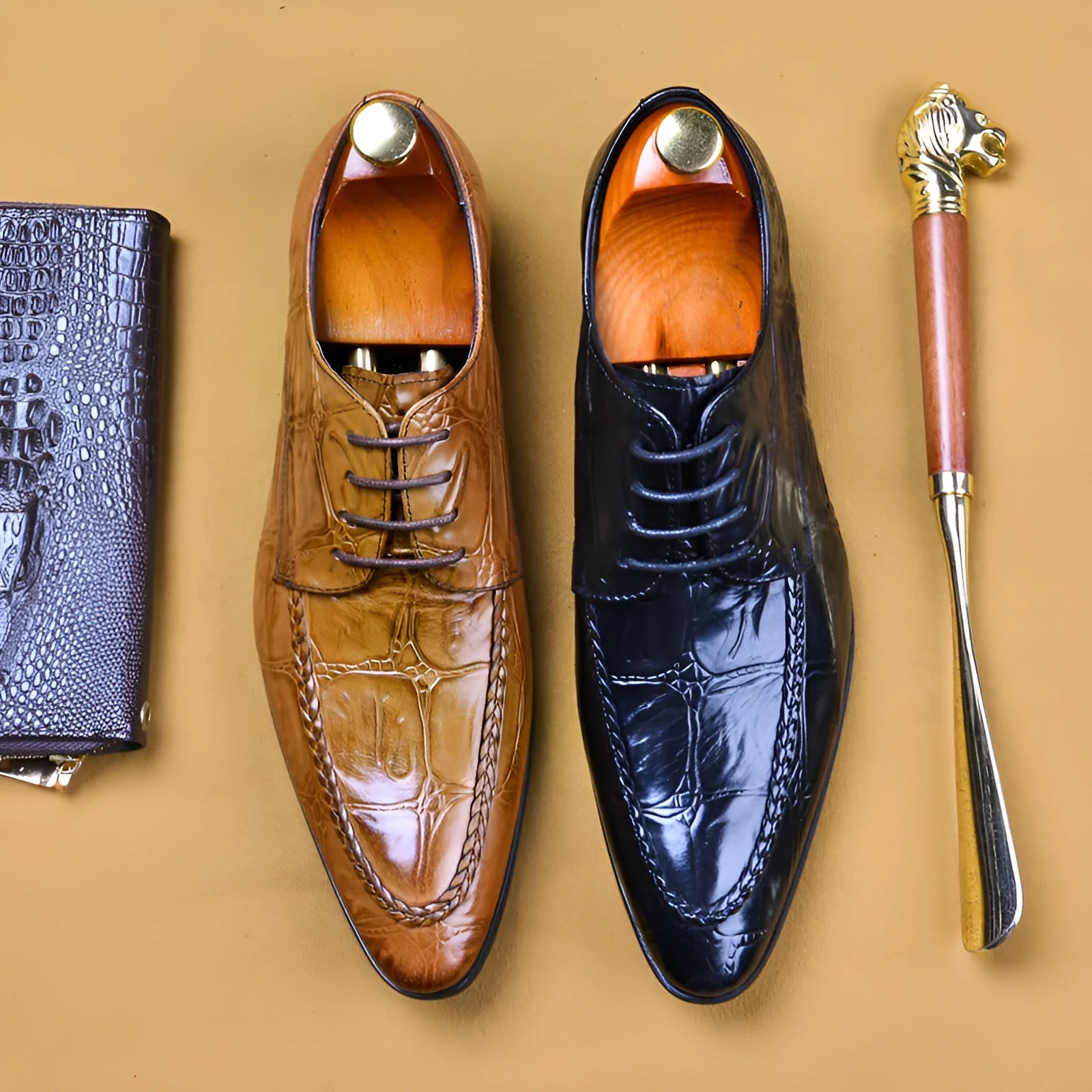 Men's black low-top leather shoes with alligator pattern texture and a silver horse bit buckle.