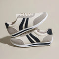 Blue and red low top lace-up leisure sneaker with a round toe and rubber sole.