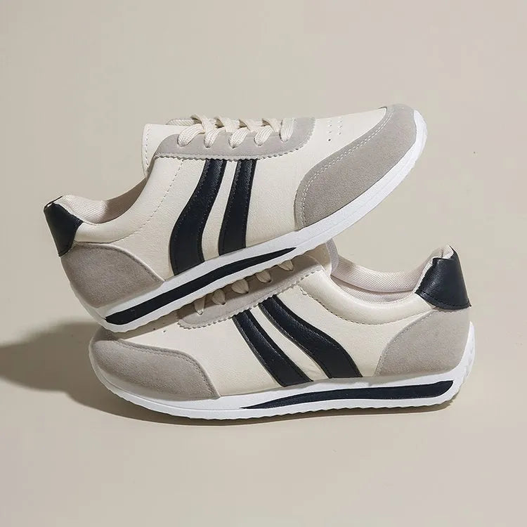 Blue and red low top lace-up leisure sneaker with a round toe and rubber sole.