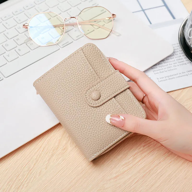 Ladies short wallet in PU leather with a lychee pattern, shown folded, in beige, pink, black, and red colour options.