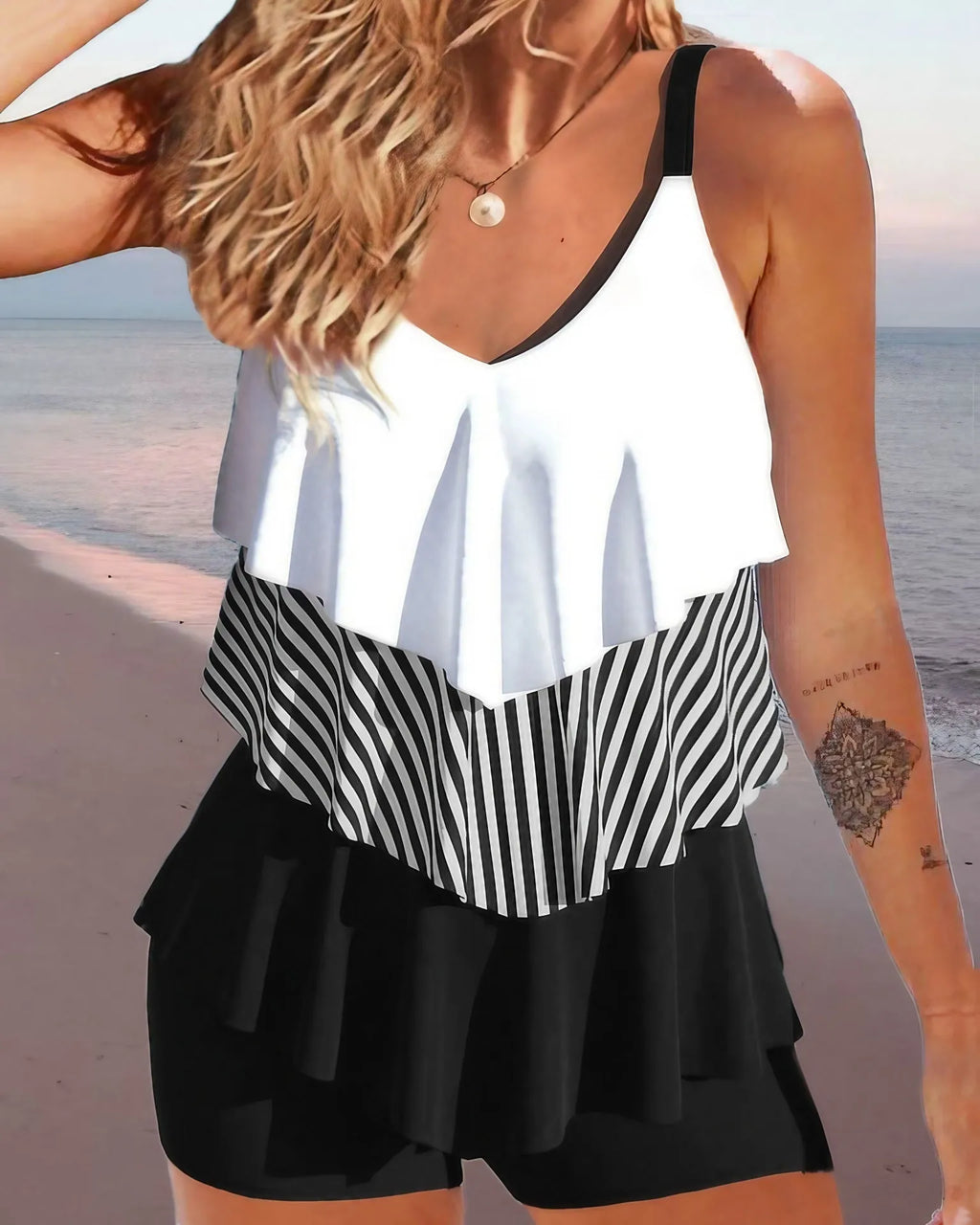 Women's backless bikini swimsuit with spaghetti straps and ruffle trim on top and split briefs.