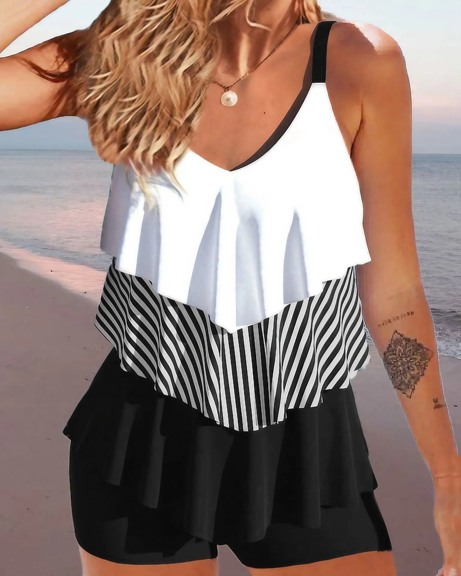 Women's backless bikini swimsuit with spaghetti straps and ruffle trim on top and split briefs.