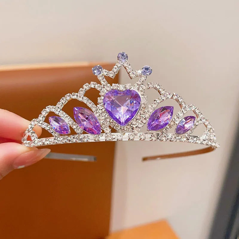 Close-up of a children's metal hairband headdress with a crown pattern in a light purple crystal colour.