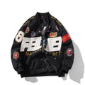 Man wearing a black motorcycle-style baseball jacket with a removable hood, featuring a side seam pocket.