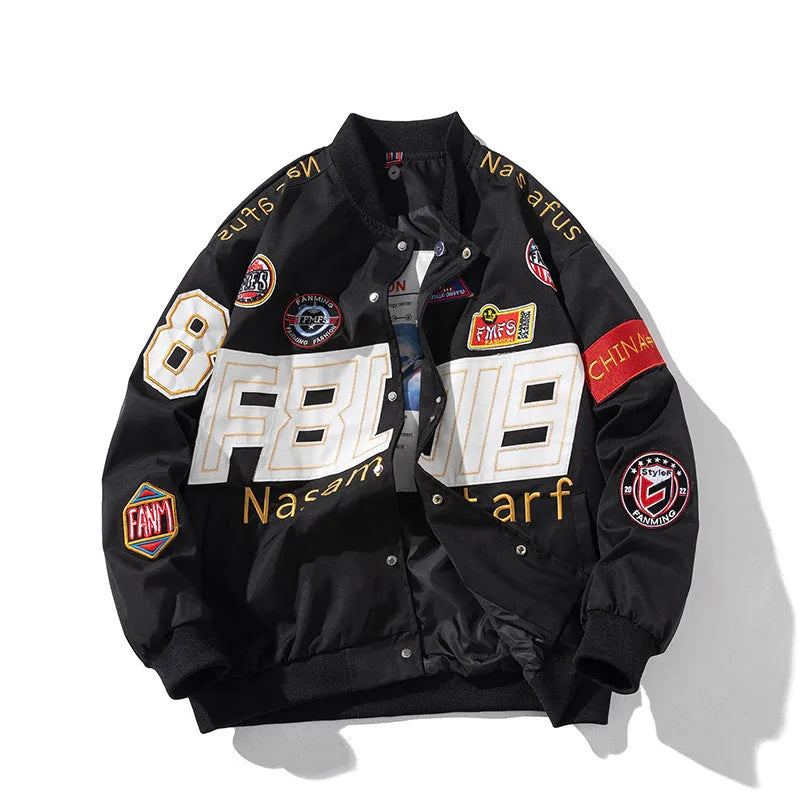 Man wearing a black motorcycle-style baseball jacket with a removable hood, featuring a side seam pocket.