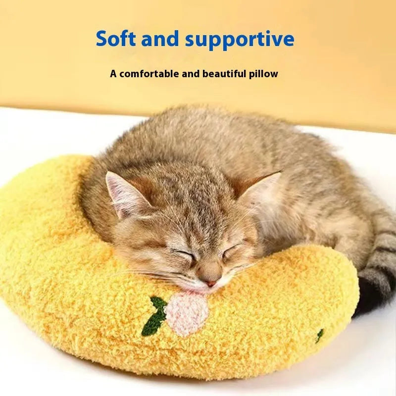 Blue U-shaped cat pillow with neck support design next to yellow question mark pet pillow