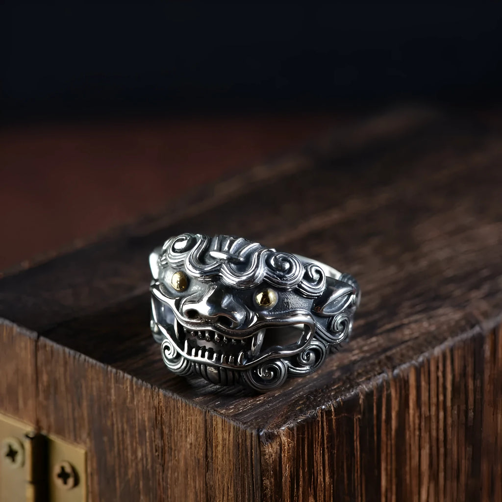 Detailed silver open ring featuring an animal zodiac beast pattern on a model's finger.