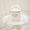 White PVC bucket shoulder bag with a heart-shaped pattern, showing its jelly-like material.