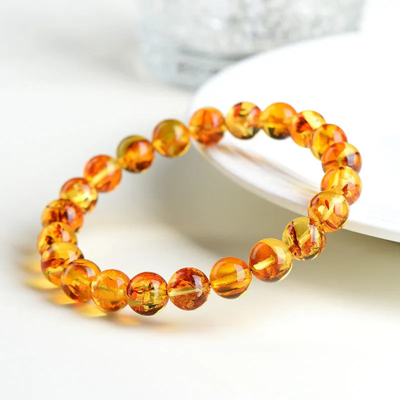 Natural yellow piebald amber bracelet with geometry beads on wrist
