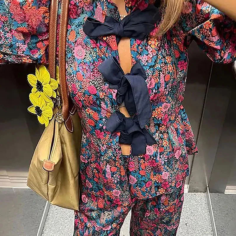 Women's floral print trousers suit set with tie-neck top and puff sleeves