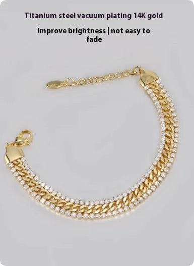 Gold-coloured titanium steel tennis bracelet with inlaid artificial gemstones on a wrist.