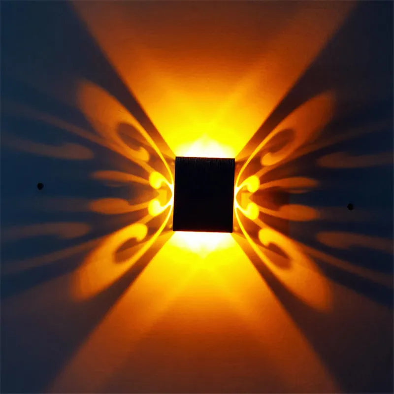 Modern aluminium butterfly-shaped LED wall lamp with remote control for changing light colours.