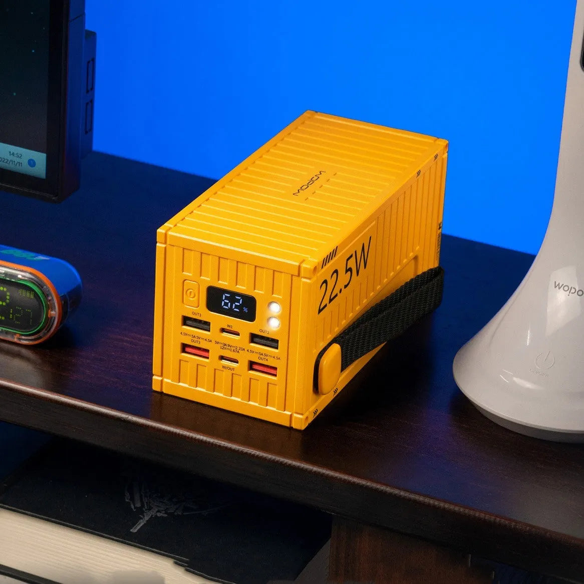 Yellow, black, and silver 50000mAh power bank with digital display showing battery level and five USB output ports.