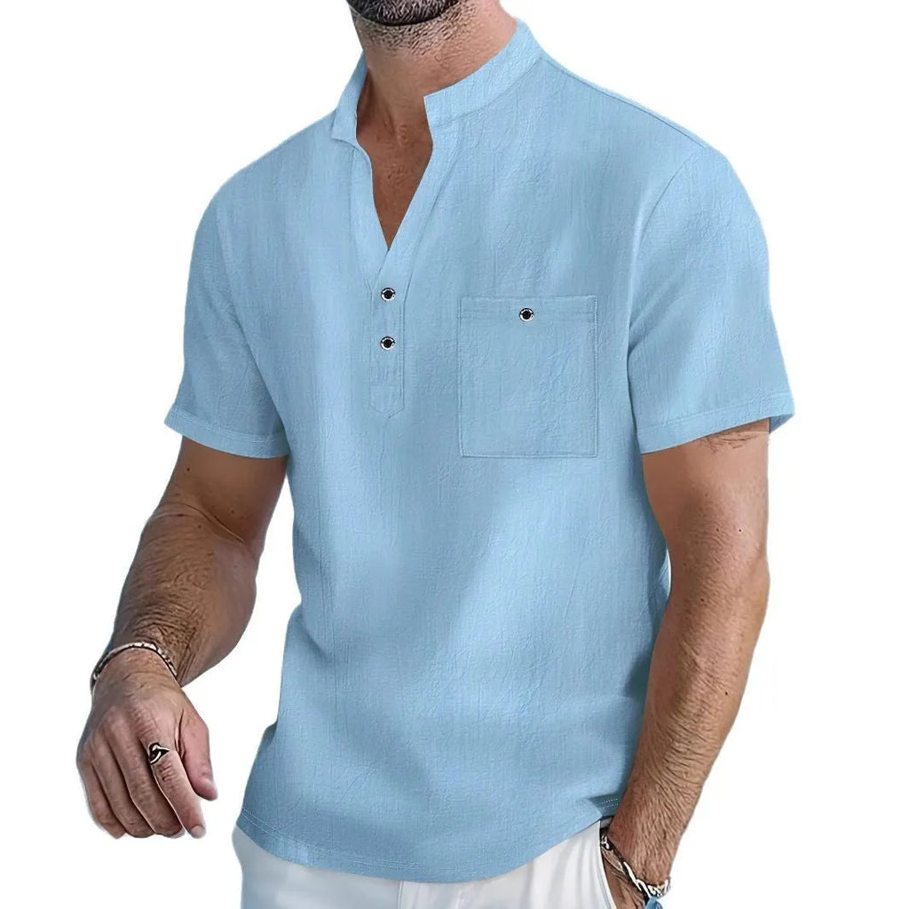 Man's light blue linen blend t-shirt with stand collar and short sleeves in a loose fit.