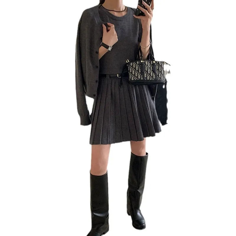 Women's art retro knitted two-piece set featuring a pleated vest skirt with 3D pattern and a long-sleeved cardigan.