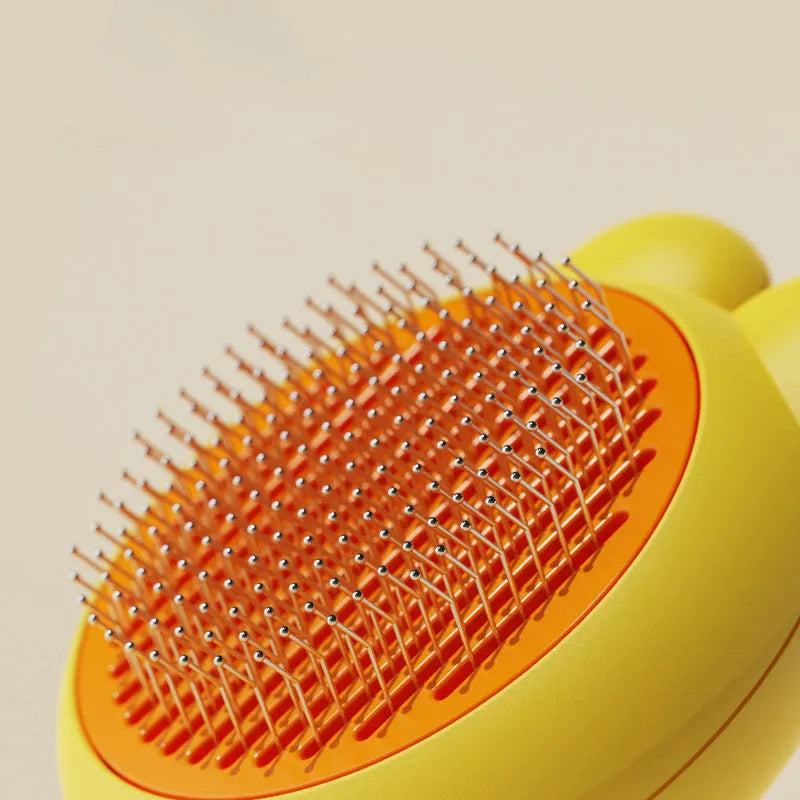 Self-cleaning pet grooming brush with coloured handle and stainless steel comb teeth with rubber tips