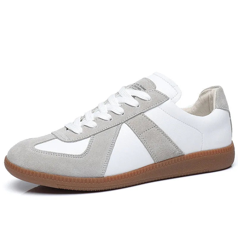 White Japanese retro low-top sneakers with matte finish and visible stitching on a rubber sole.