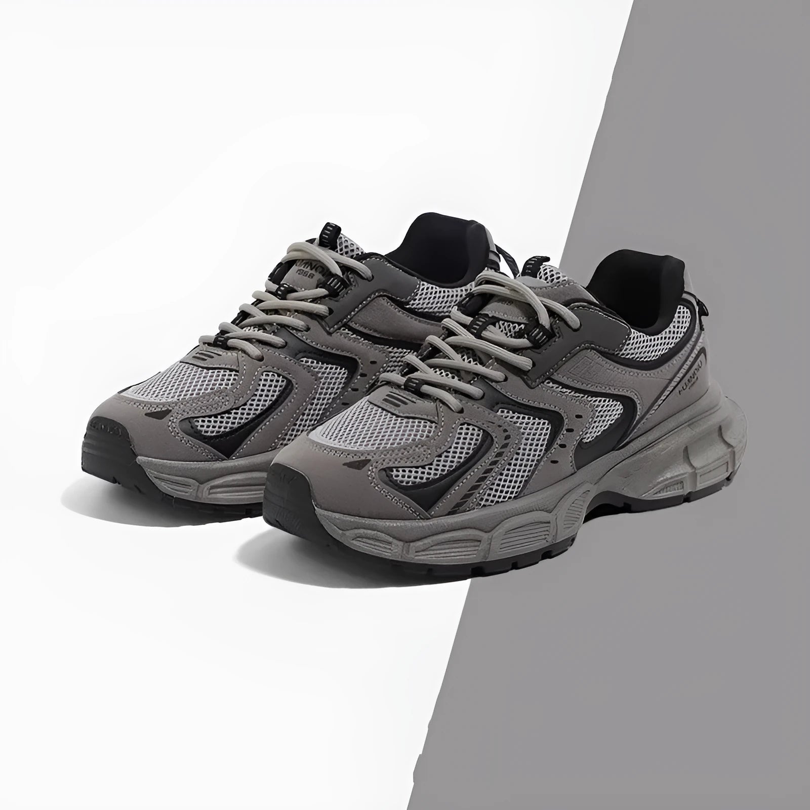 Grey low-top platform casual sneakers with leather stitching detail on a PU mesh upper.