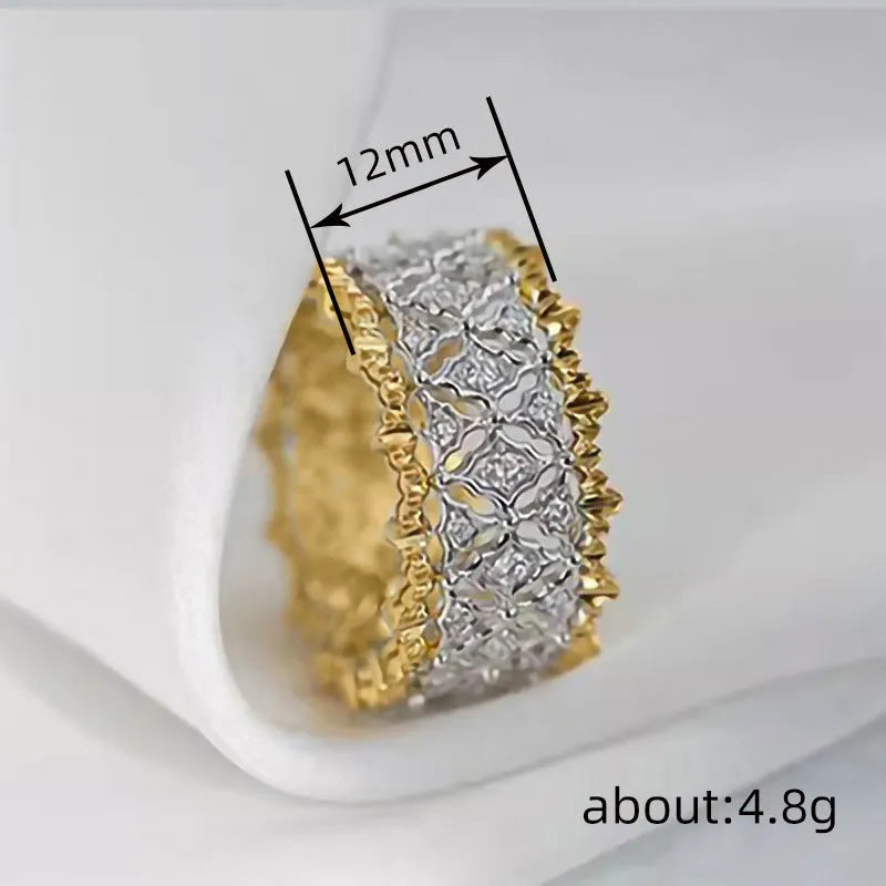 Geometric gold two-tone women's ring with round cubic zirconia stone on copper base.