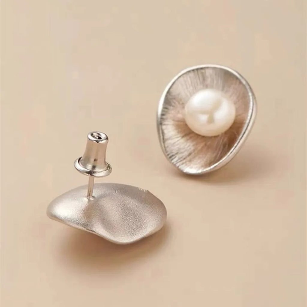 Gold-coloured geometric pearl stud earrings made from sterling silver with electroplated finish