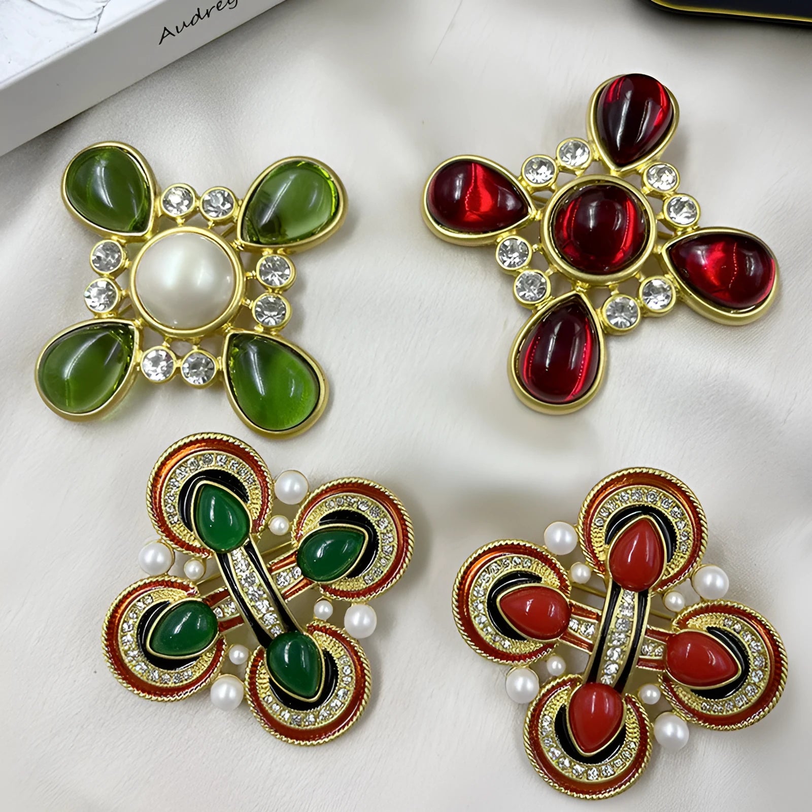 Close-up of a metallic medieval baroque cross brooch with crystal details on a dark background