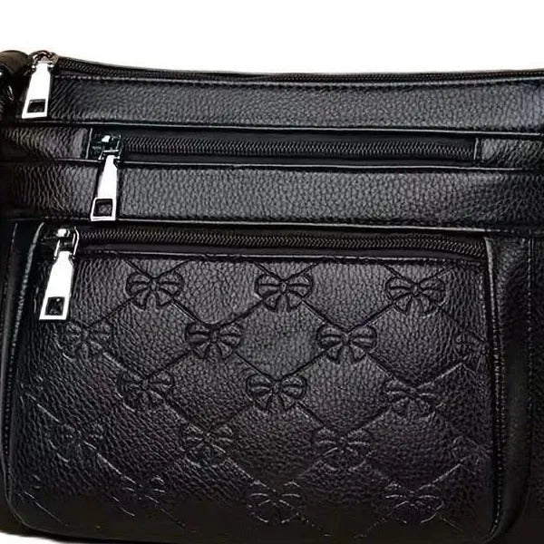Butterfly black PU leather crossbody messenger bag showing embossed texture and sewing thread details