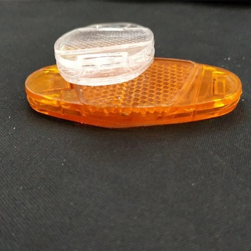 White and yellow plastic bicycle reflector spoke decorations showing 7.2cm length and 3.5cm width dimensions