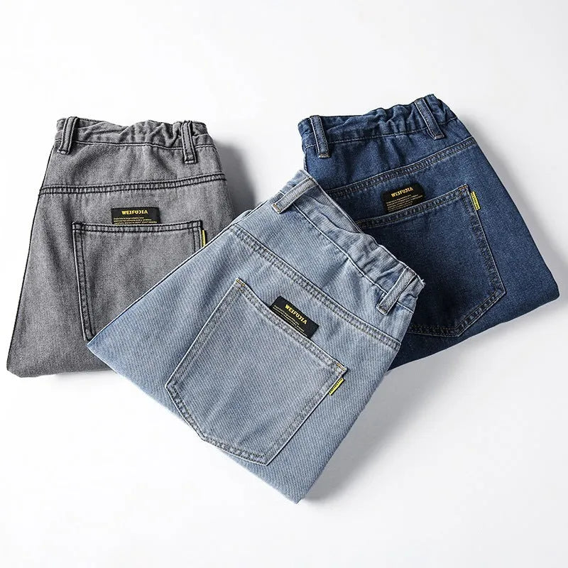 Men's loose straight-leg casual jeans in dark blue cotton fabric with a zip fly.
