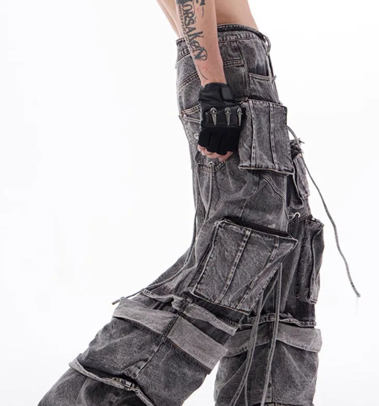 Grey distressed denim overalls with rope stitching on a hanger.