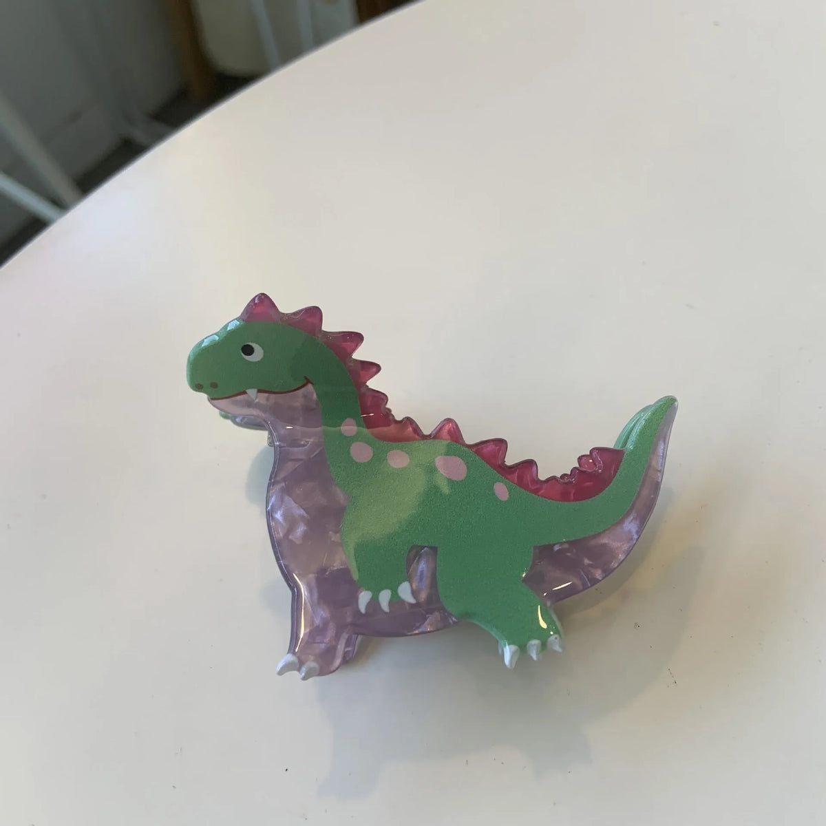 Acrylic dinosaur jaw hair clip showing six colour options including Pink Pterosaur and Blue Little Dinosaur designs
