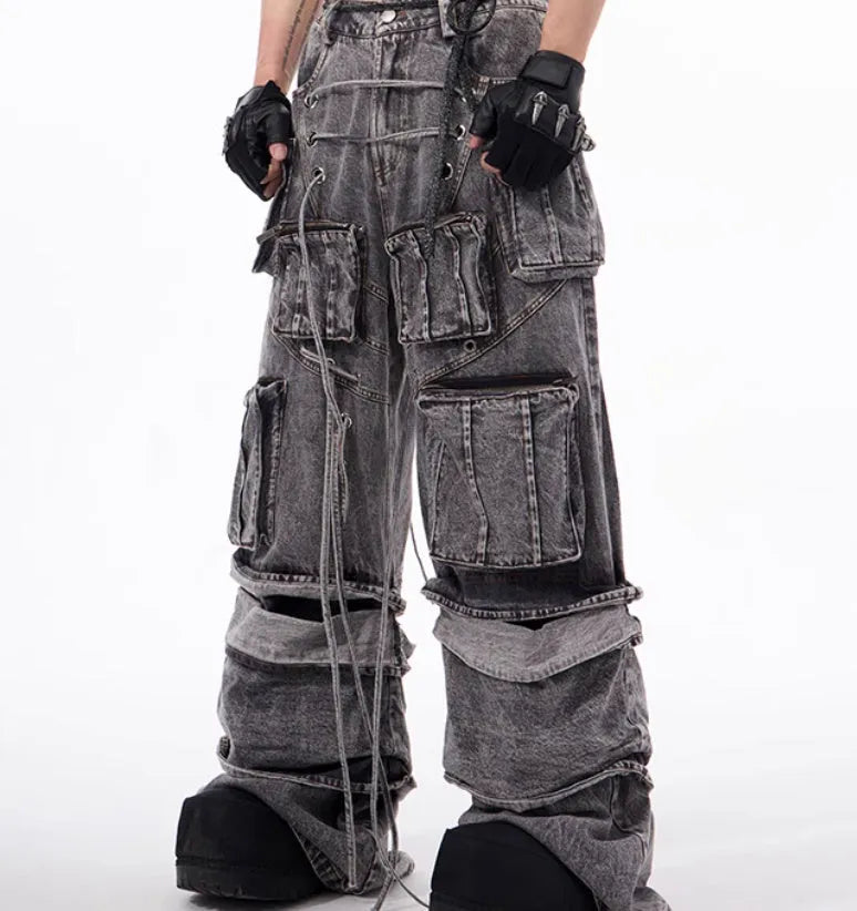 Grey distressed denim overalls with rope stitching on a hanger.