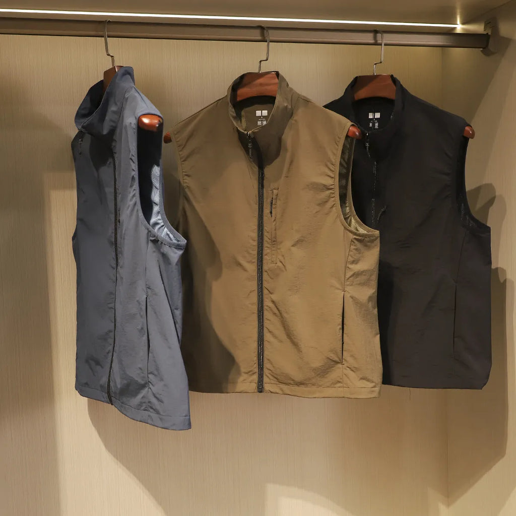 Men's straight-cut nylon vest cardigan in army green with side seam pockets, shown open as a lightweight layer.
