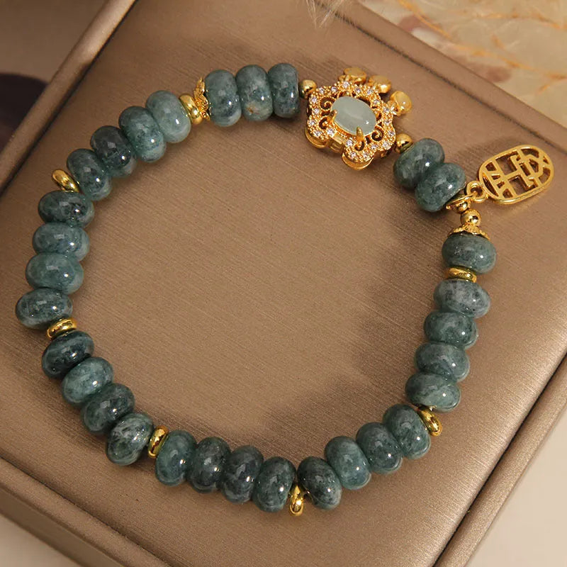 Natural emerald green jade abacus beads bracelet with a metallic alloy safety lock clasp.