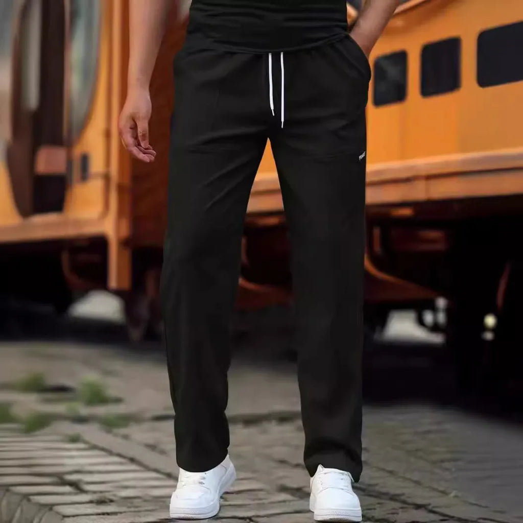 Men's polyester trousers in light grey, shown flat, with a size label indicating S-XXXL range.
