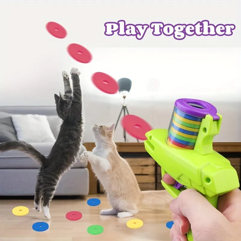 Green interactive cat toy launcher with three foam discs for battery-free feline play