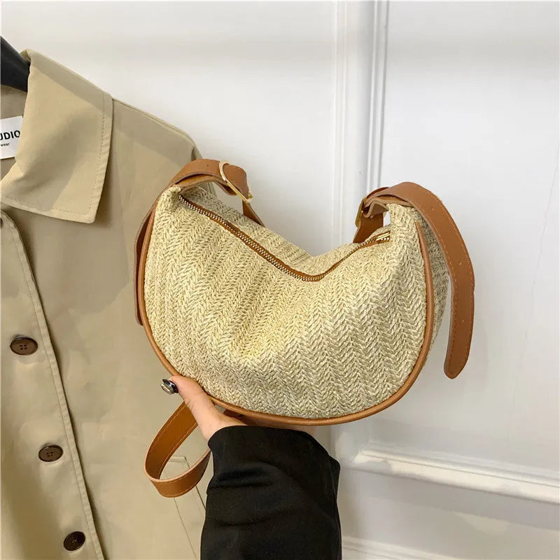 Women's straw woven crossbody bag showing internal mobile phone pocket and file compartment.