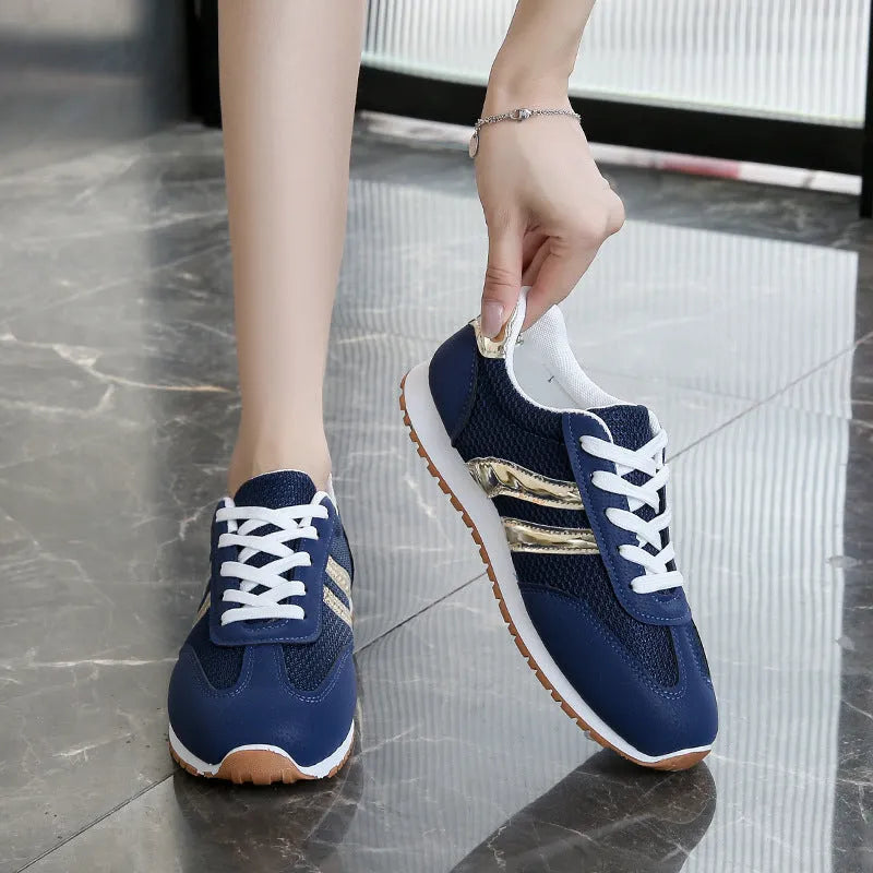 Blue women's casual tennis shoes with cross straps and a white rubber sole.
