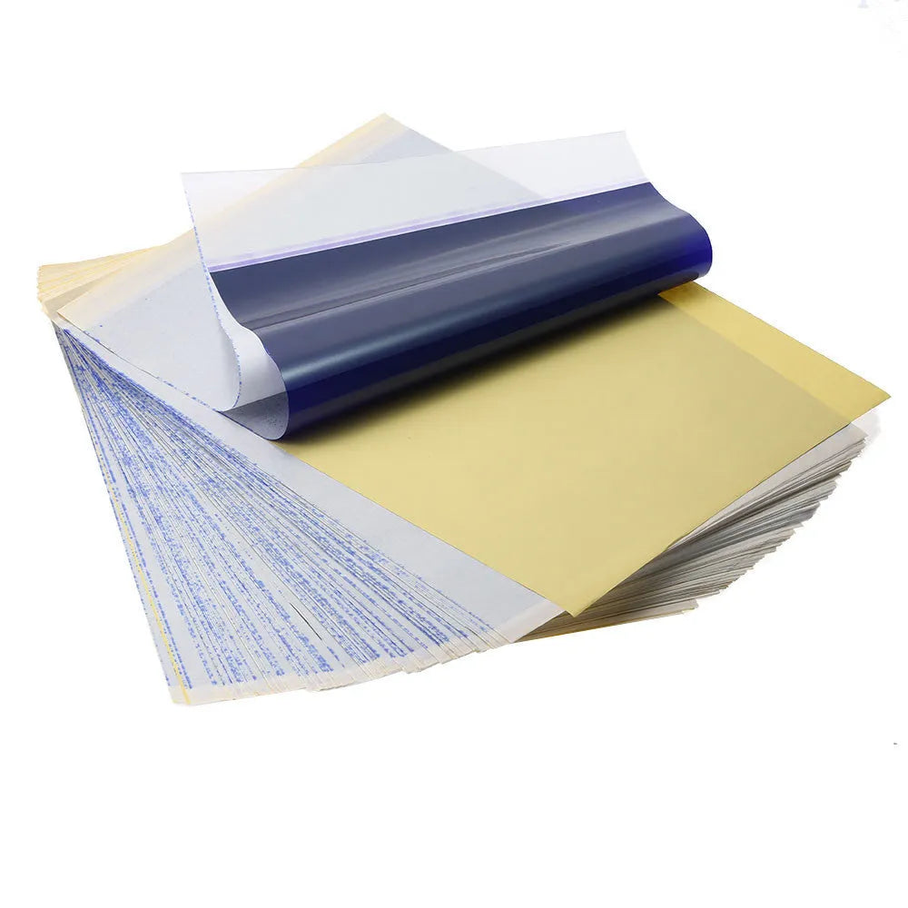 Stack of A4 tattoo transfer paper sheets showing quadruple copy layers for stencil making