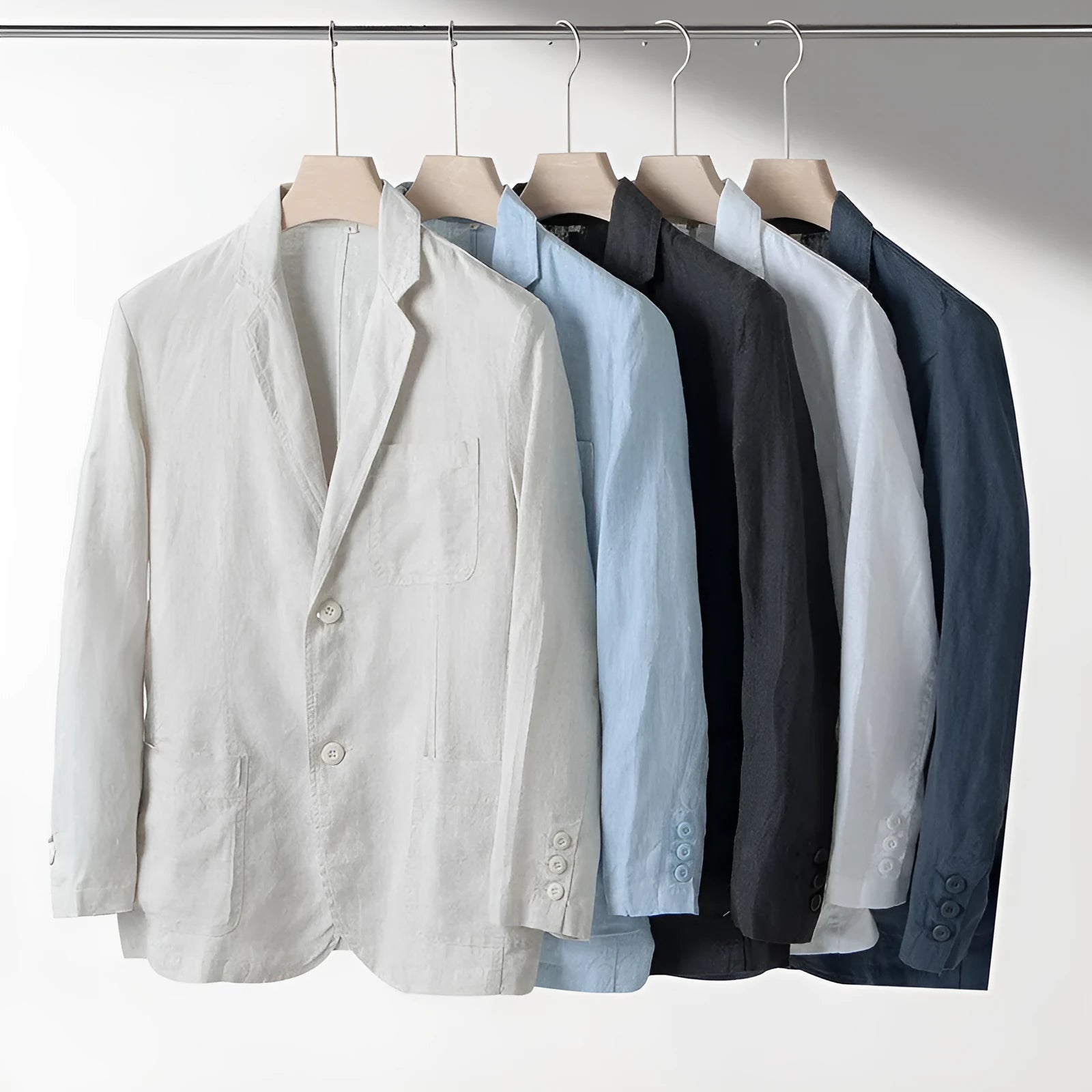 Men's casual linen suit jacket in a solid colour on a hanger, showing long sleeves and loose fit.