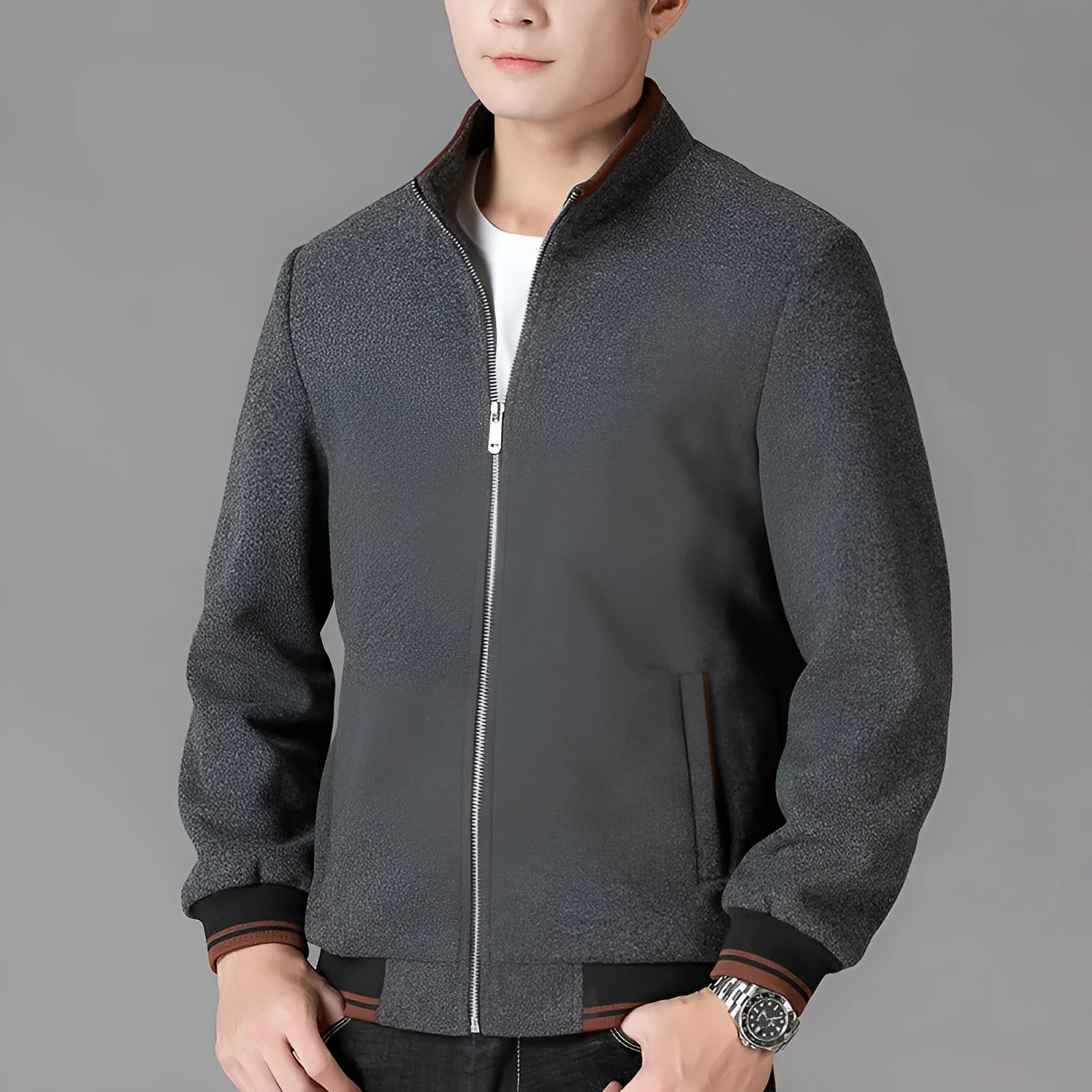 A grey men's sports-style fleece jacket with long sleeves, shown on a hanger.