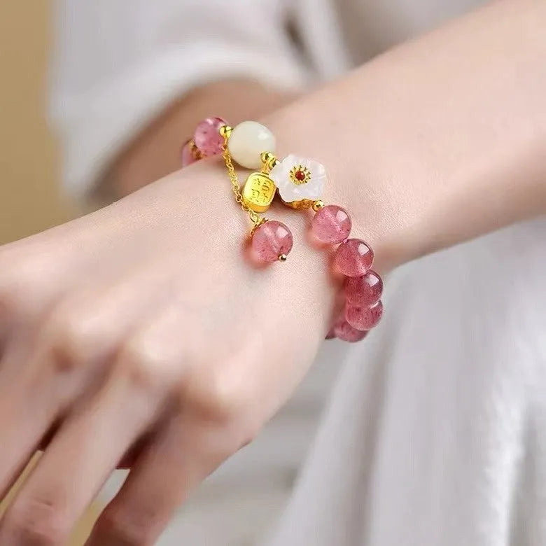 Handmade strawberry quartz crystal bracelet for women showing natural bead details on wrist