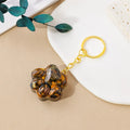 Natural crystal cat's paw keychain pendant on a metal ring in one of ten random stone colours.