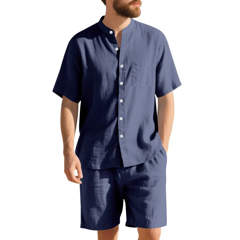 Men's light blue linen two-piece suit with short-sleeved henry collar shirt jacket and shorts on a hanger.