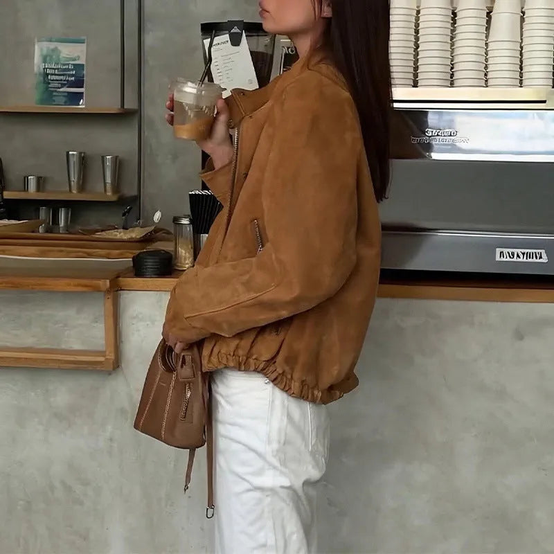 Solid colour loose-fit polyester jacket with long sleeves on a hanger