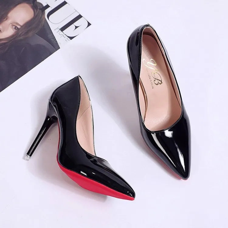 Women's black stiletto heel pointed toe pump shoe on a white background.