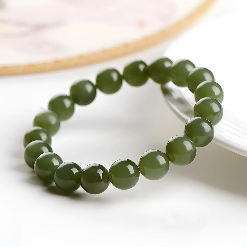 Polished Hetian jade ball bracelet showing spherical beads on a wrist, available in deep or shallow ice-clear colours.
