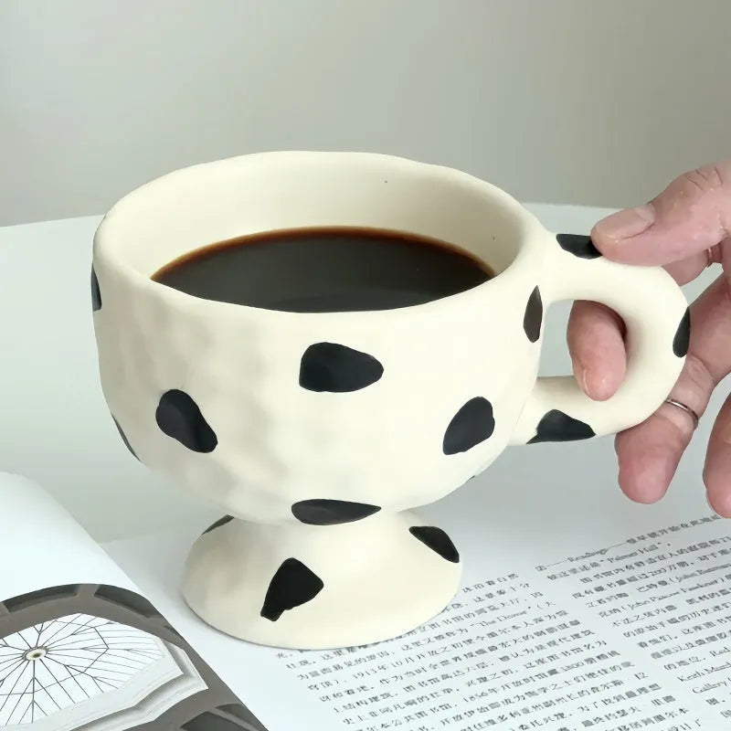 Irregular shaped hand-pinched ceramic mug in solid colour showing unique contours and modern design