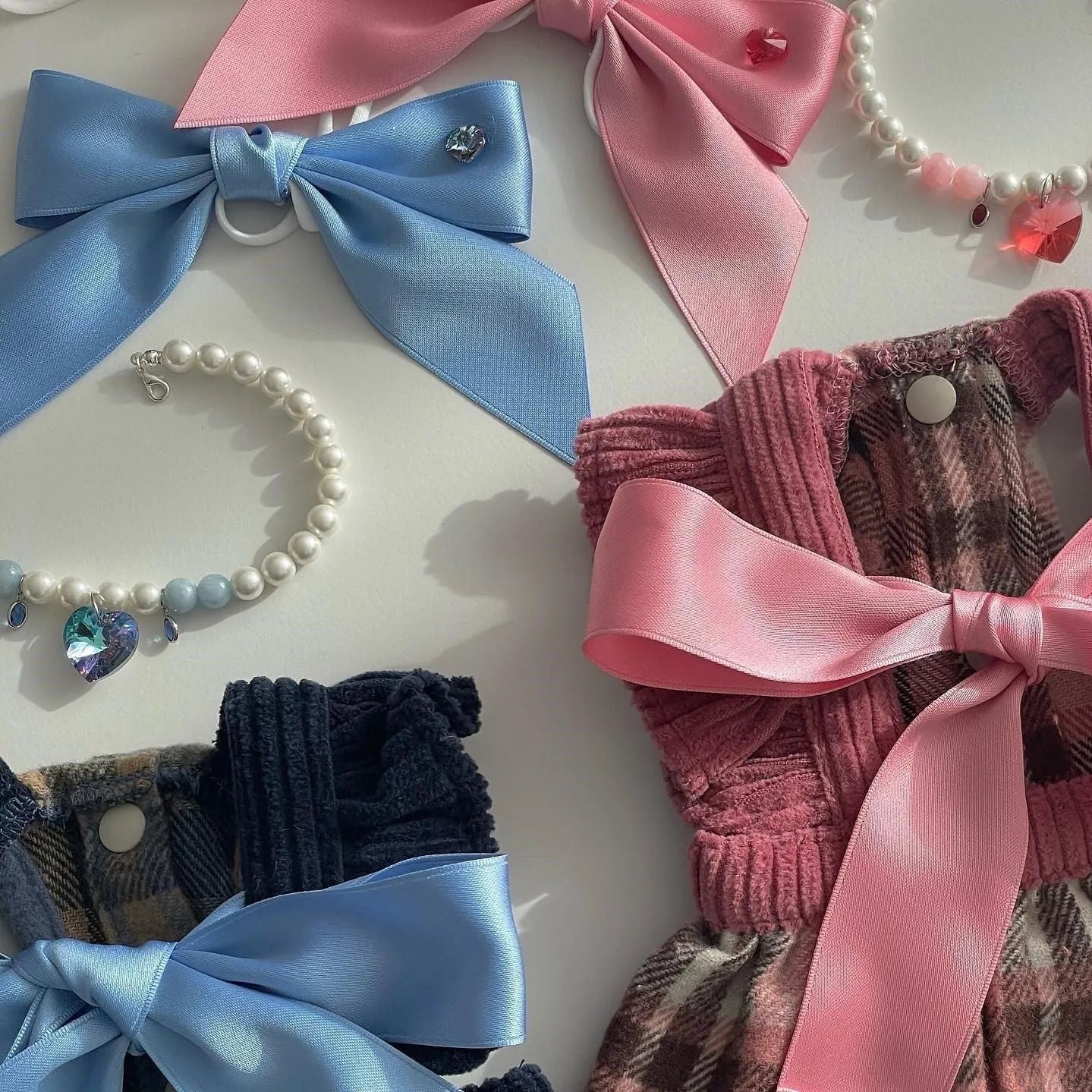 Blue princess style bow dog hair band with adjustable tension on a white background.